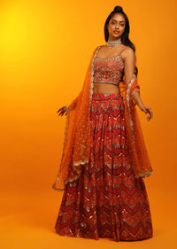 Red And Burnt Orange Lehenga In Georgette With Chevron And Bandhani Print And Mirror Embroidered Choli