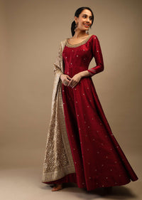 Ruby Wine Anarkali Suit In Raw Silk With Brocade Buttis, Zardosi Embroidered Neckline And Contrasting Gold Brocade Dupatta
