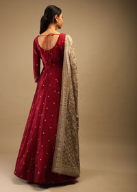 Ruby Wine Anarkali Suit In Raw Silk With Brocade Buttis, Zardosi Embroidered Neckline And Contrasting Gold Brocade Dupatta
