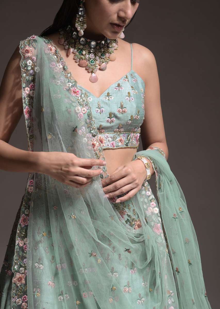 Sage Green Lehenga Choli In Raw Silk With Vibrant Resham Embroidered Cluster Of Summer Blooms And Buttis