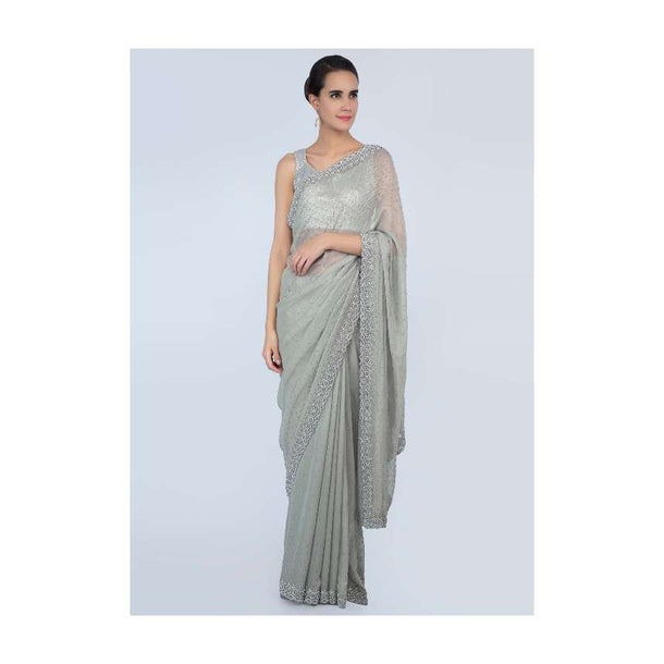 Sage green shimmer georgette saree adorn with moti scattered and heavy stone embroidered border only on Kalki