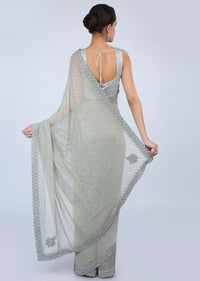 Sage green shimmer georgette saree adorn with moti scattered and heavy stone embroidered border only on Kalki