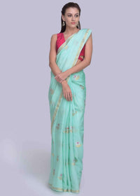 Sea green dola silk saree in silver and golden weaved butti only on Kalki