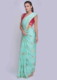 Sea green dola silk saree in silver and golden weaved butti only on Kalki