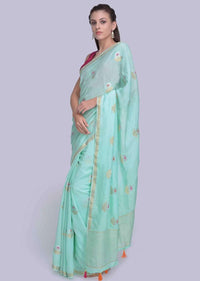 Sea green dola silk saree in silver and golden weaved butti only on Kalki