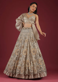 Oyster Lehenga And A Crop Top With One Sided Balloon Sleeves Tie Up Top And Cut Dana Motifs Embroidery