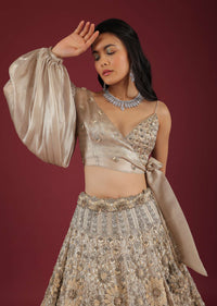 Oyster Lehenga And A Crop Top With One Sided Balloon Sleeves Tie Up Top And Cut Dana Motifs Embroidery