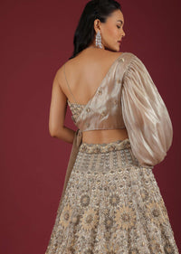 Oyster Lehenga And A Crop Top With One Sided Balloon Sleeves Tie Up Top And Cut Dana Motifs Embroidery