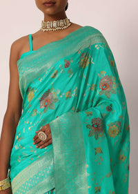 Teal Saree In Banarasi Silk With Floral Motifs And Unstitched Blouse Piece