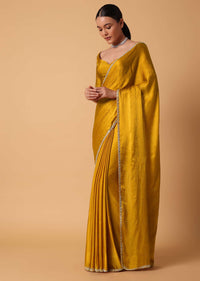 Mustard Satin Chinnon Saree With Mirror Detail Border And Unstitched Blouse Piece