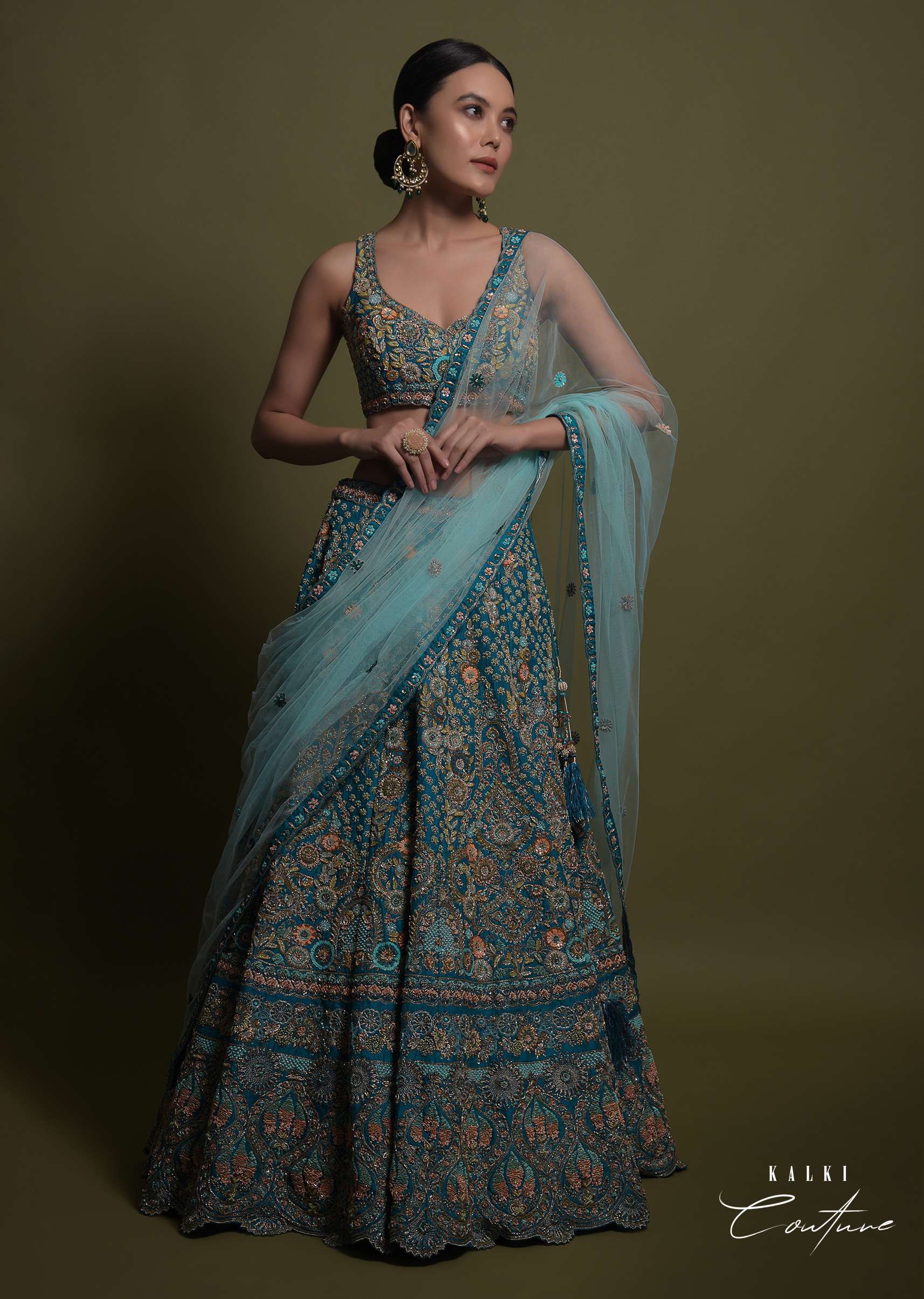 Teal Lehenga Choli In Raw Silk Hand Crafted With Embossed Embroidery In Heritage Floral Pattern