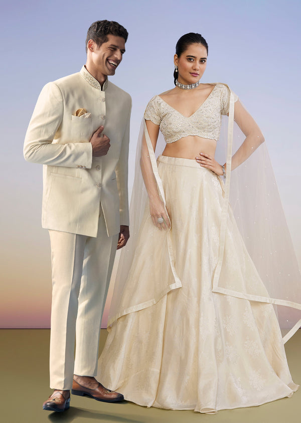 Ivory Regal Duo – Embroidered Lehenga For Her And Jacquard Jodhpuri Suit For Him