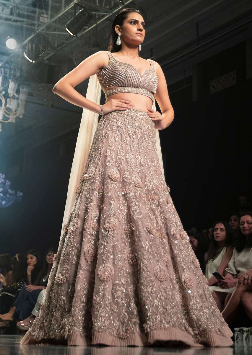 Shell Champagne Lehenga Hand Crafted In Heavy Embroidered Net In Floral Motifs