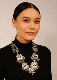 Silver Necklace With White Mirror Embellished Crescent Ethnic Motifs And Bunches Of Ghungroo Tassels