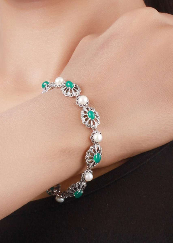 Silver Plated Bracelet With Carved Flowers And Embellished With Green Gemstone And Pearls Made In Sterling Silver By Sangeeta Boochra