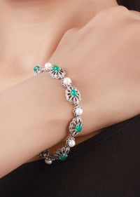 Silver Plated Bracelet With Carved Flowers And Embellished With Green Gemstone And Pearls Made In Sterling Silver By Sangeeta Boochra