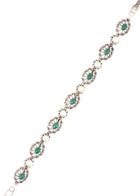 Silver Plated Bracelet With Carved Flowers And Embellished With Green Gemstone And Pearls Made In Sterling Silver By Sangeeta Boochra