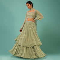 Powder Green Layered Lehenga And Crop Top With Balloon Sleeves And Cut Dana Detailing