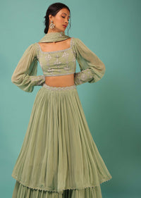 Powder Green Layered Lehenga And Crop Top With Balloon Sleeves And Cut Dana Detailing