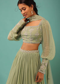 Powder Green Layered Lehenga And Crop Top With Balloon Sleeves And Cut Dana Detailing