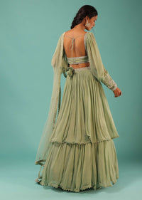 Powder Green Layered Lehenga And Crop Top With Balloon Sleeves And Cut Dana Detailing