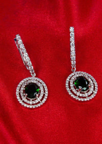 Stone studded diamond dangler with emerald green  stone at the center only on Kalki