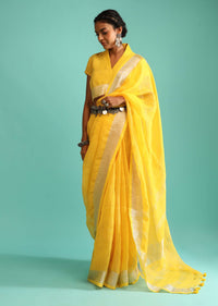 Sun Yellow Saree In Linen With Silver Brocade Border And Striped Pallu Along With A Matching Unstitched Blouse