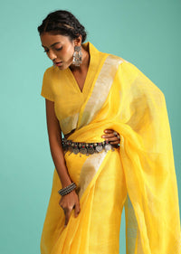 Sun Yellow Saree In Linen With Silver Brocade Border And Striped Pallu Along With A Matching Unstitched Blouse