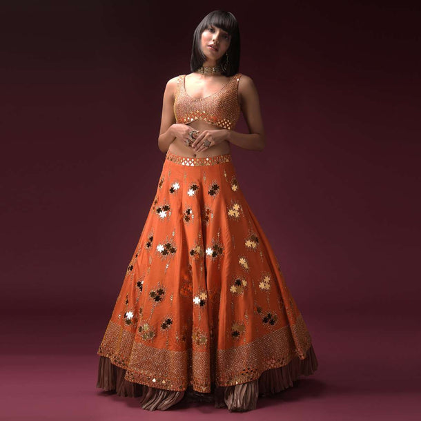 Tangerine Orange Lehenga Choli In Raw Silk Heavily Embroidered Using Geometric Cut Mirrors And Zari Work