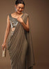 Taupe Grey Ready-Pleated Saree With A Crop Top In Foil Applique Embellishment Sleeveless With A Tie-Up Tassel Dori At The Back.