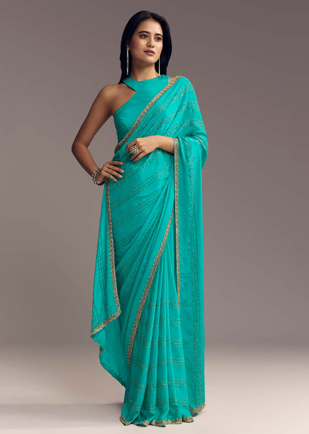 Turquoise Blue Embroidered Chinon Saree With Wavy Border