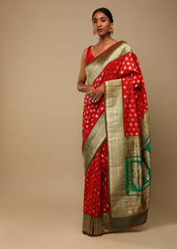 Vermillion Red Saree In Art Handloom Silk With Green Woven Border And Two Toned Buttis Along With Unstitched Blouse