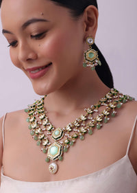 White Layered Kundan Necklace And Earring Set With Carved Motif