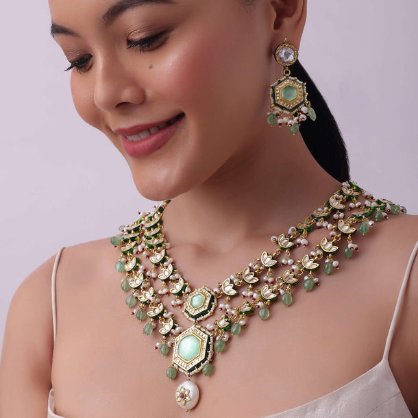 White Layered Kundan Necklace And Earring Set With Carved Motif