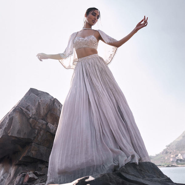 White Ruched Lehenga With Spaghetti Blouse And Cape