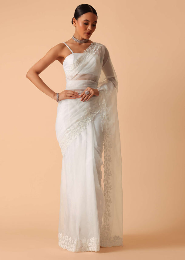 White Saree In Organza With Floral Motif Border And Unstitched Blouse Piece