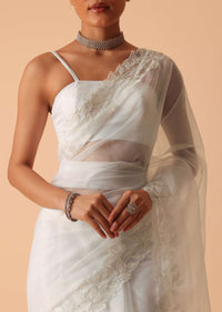 White Saree In Organza With Floral Motif Border And Unstitched Blouse Piece