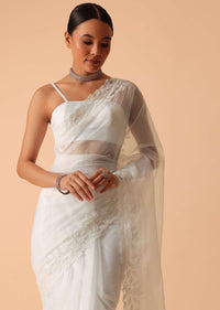 White Saree In Organza With Floral Motif Border And Unstitched Blouse Piece