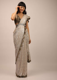 White Sequins Saree With A Contrasting Henna Green Sleeveless Blouse