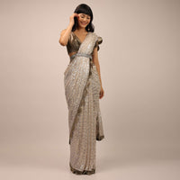 White Sequins Saree With A Contrasting Henna Green Sleeveless Blouse