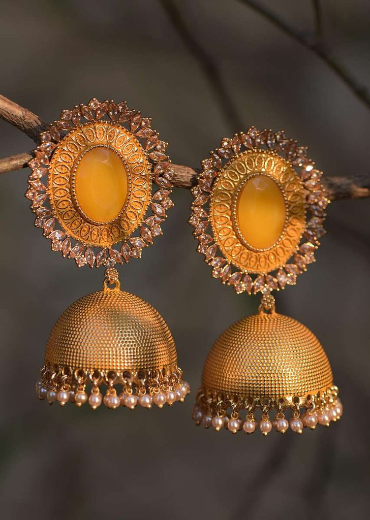 Yellow Embossed Jhumkas With Stone Studded Oval Motif, Crystals And Dangling Pearl Online - Kalki Fashion