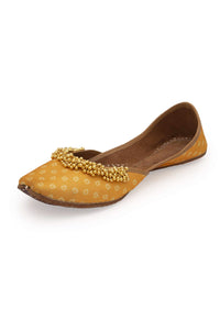 Yellow Print Juttis In Silk With Ghungroo Embellishment And Geometric Print