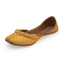 Yellow Print Juttis In Silk With Ghungroo Embellishment And Geometric Print