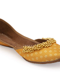 Yellow Print Juttis In Silk With Ghungroo Embellishment And Geometric Print