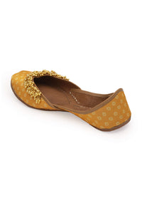 Yellow Print Juttis In Silk With Ghungroo Embellishment And Geometric Print