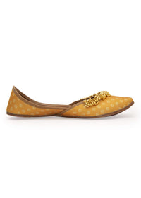 Yellow Print Juttis In Silk With Ghungroo Embellishment And Geometric Print