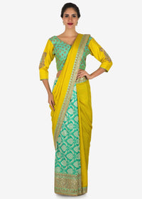 Yellow saree in cotton with ready stitched blouse embellished in zari butti embroidery only on Kalki