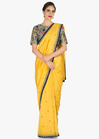Yellow saree in silk with ready stitched blouse beautified in resham and cut dana work only on Kalki