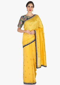 Yellow saree in silk with ready stitched blouse beautified in resham and cut dana work only on Kalki