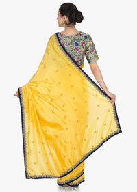 Yellow saree in silk with ready stitched blouse beautified in resham and cut dana work only on Kalki